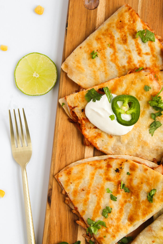 a Tex Mex meal made from tortillas, seasoned meat, and cheese then cooked over medium heat.
