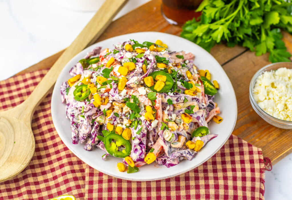 a white bowl with a corn salad.