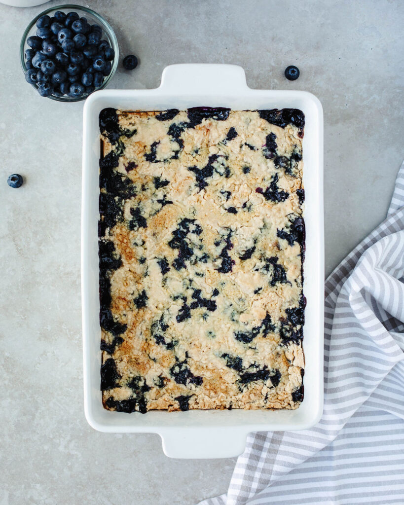 Blueberry Dump Cake in a white 9x13 baking dish.
