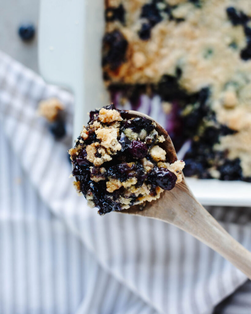 a wooden spoon with cake scooped out.