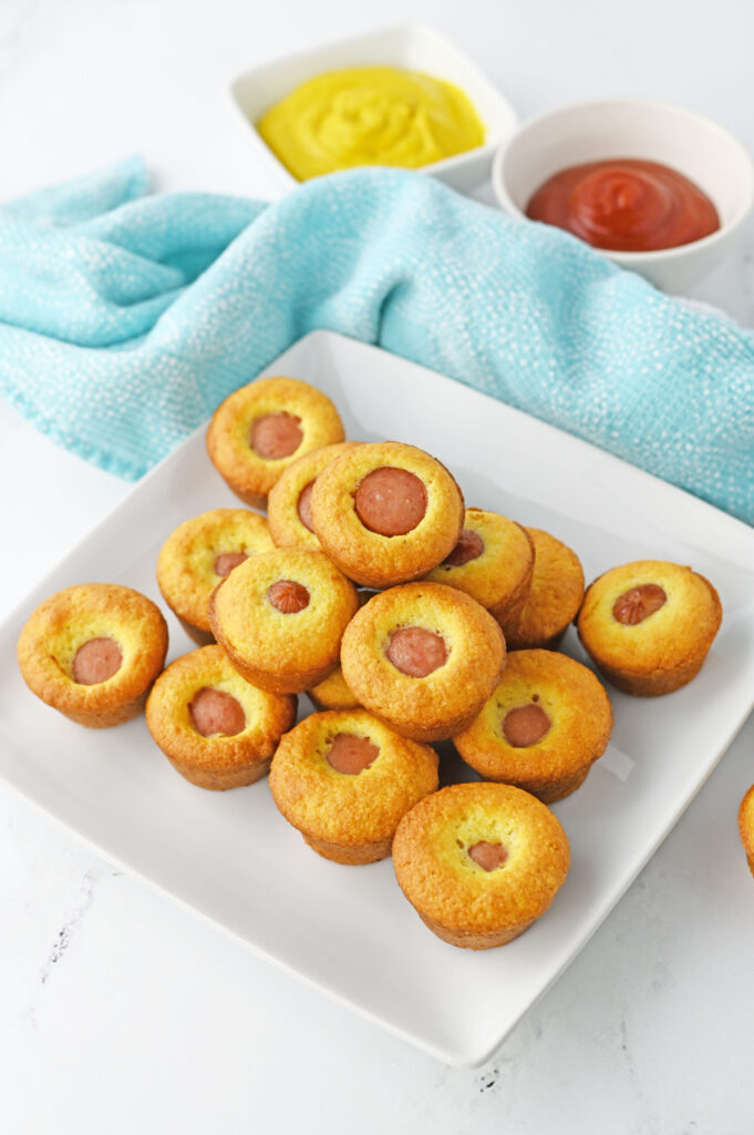 Mini Corn Dog Muffins on a white serving plate.