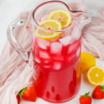 a glass pitcher of Berry Lemonade ready to serve.
