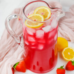 a glass pitcher of Berry Lemonade ready to serve.