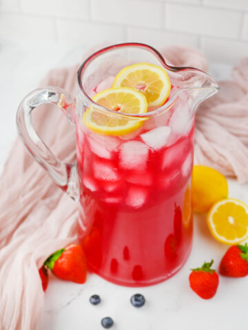 a glass pitcher of Berry Lemonade ready to serve.