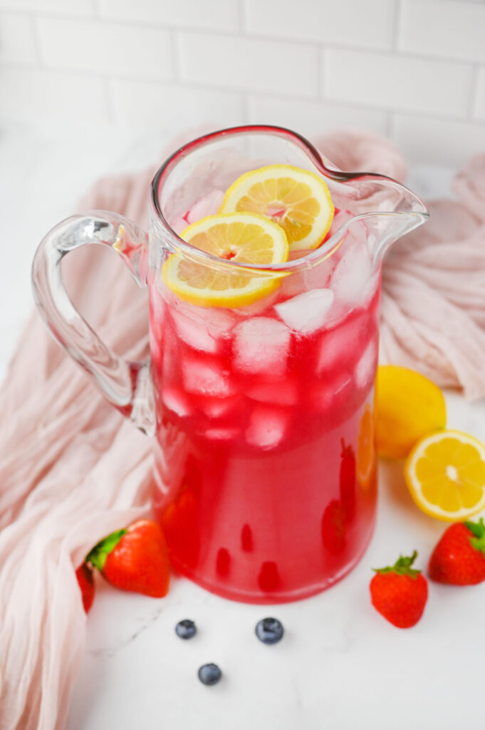 a glass pitcher of Berry Lemonade ready to serve.