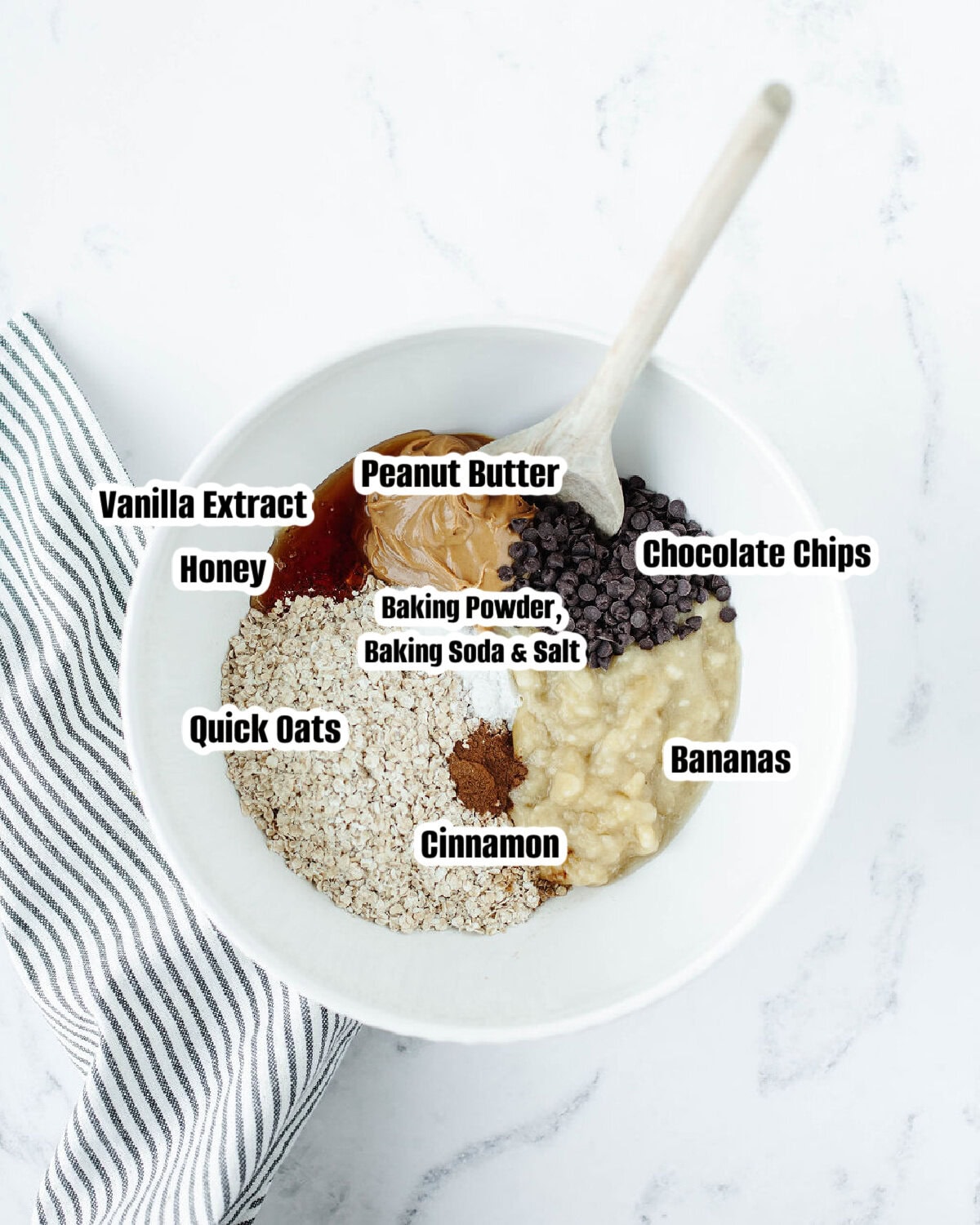 All the ingredients needed to make Banana Oat Peanut Butter Cookies in a mixing bowl.