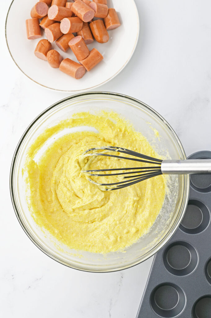 cornbread batter mixed in a glass bowl.