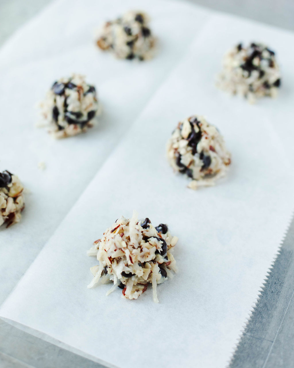 cookie dough scooped onto a parchment paper lined cookie sheet.