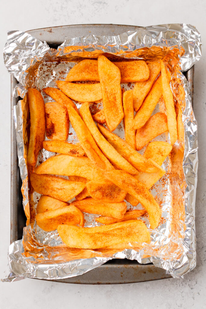 taco seasoned fries on a baking sheet.