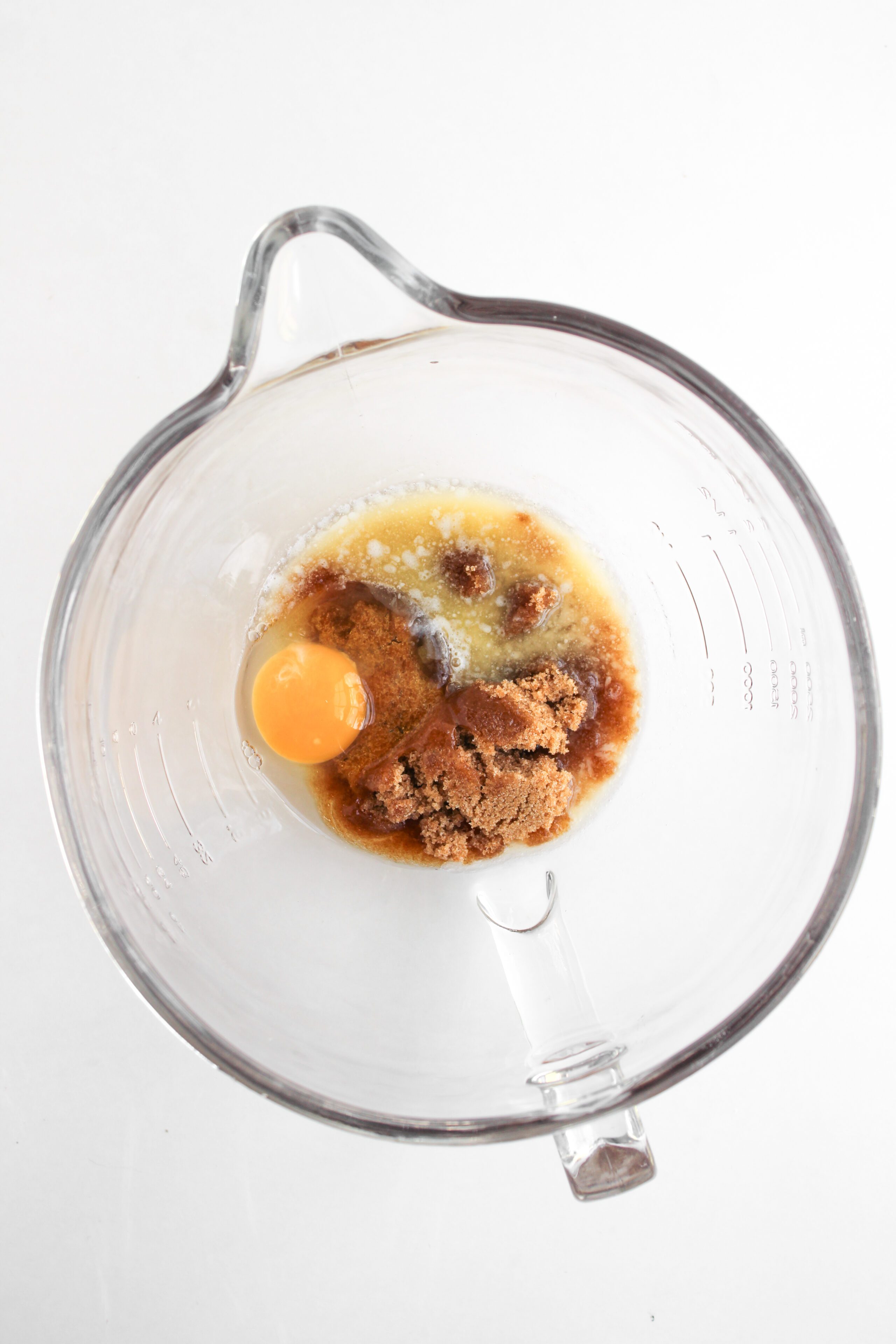 butter, eggs, and brown sugar in a glass mixing bowl.