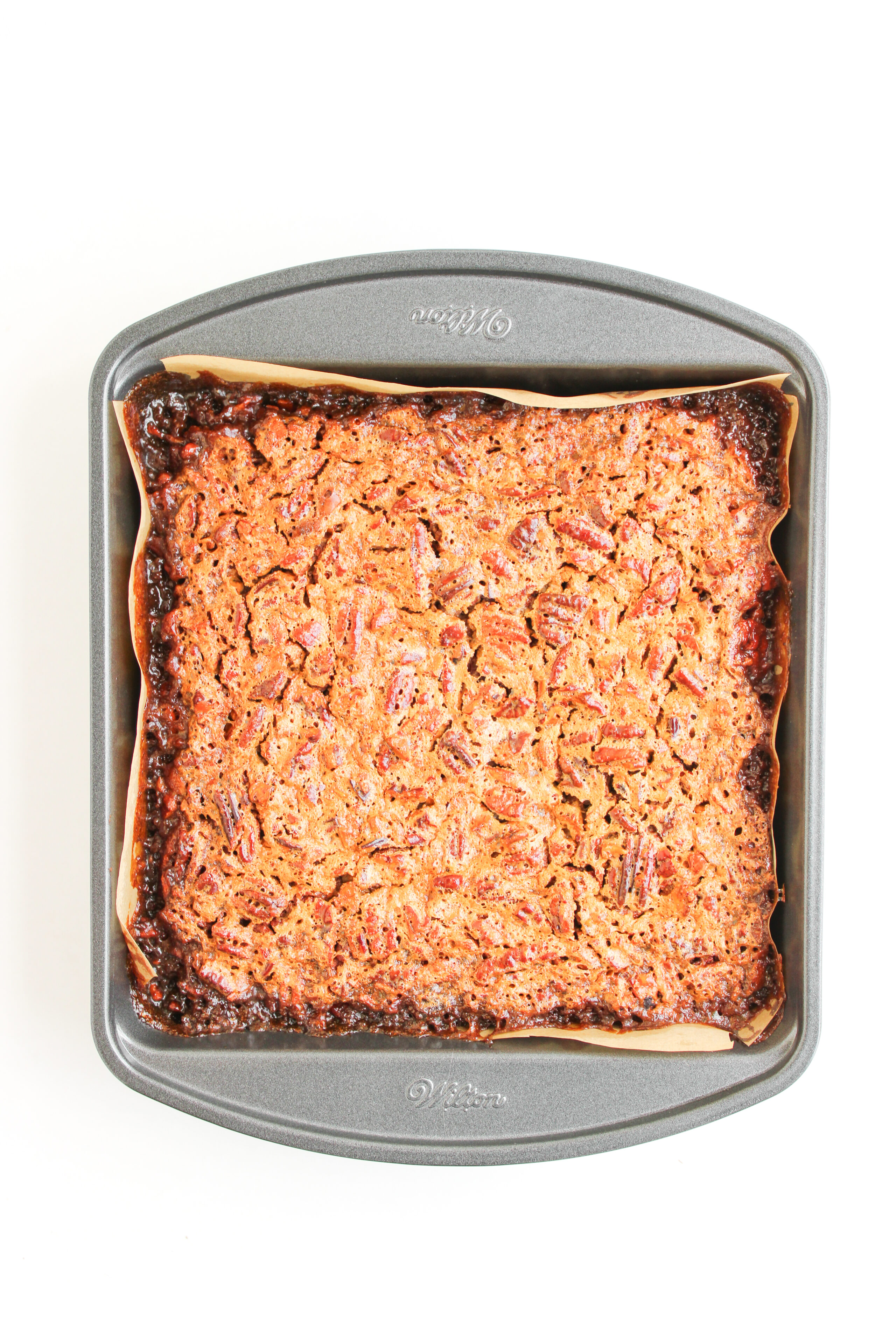 baked pecan pie brownies in a 9x9 baking dish.