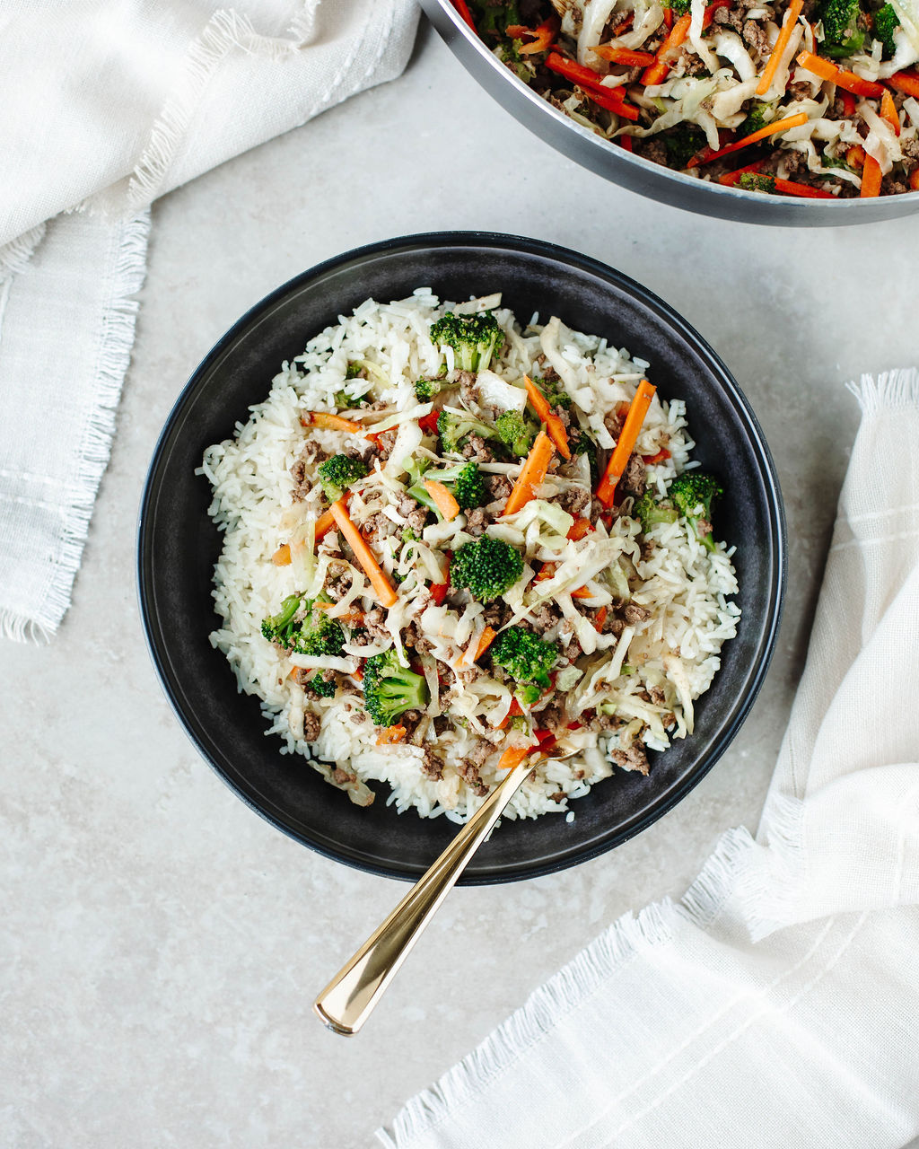 Bowl of egg roll in a bowl served over white rice.