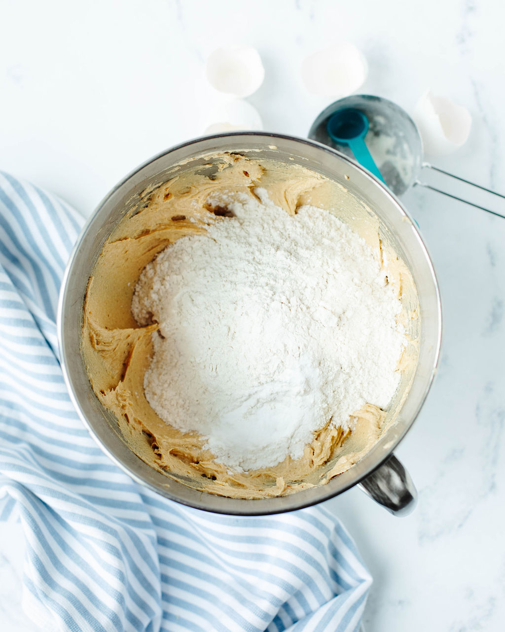 the dry ingredients folded into cookie dough in a mixing bowl.