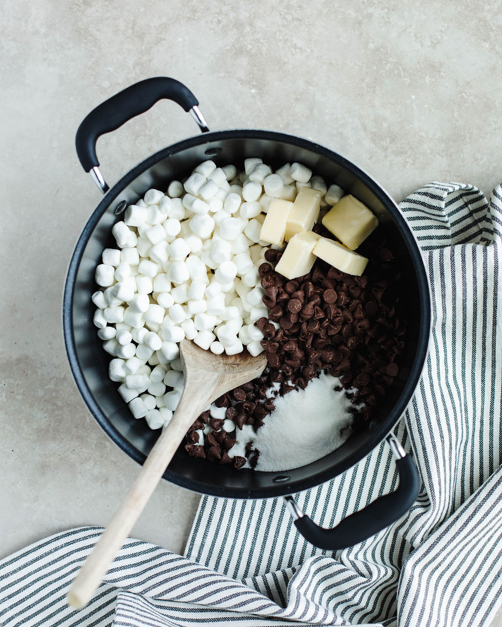 marshmallows, butter, sugar, water, and chocolate chips in a saucepan.