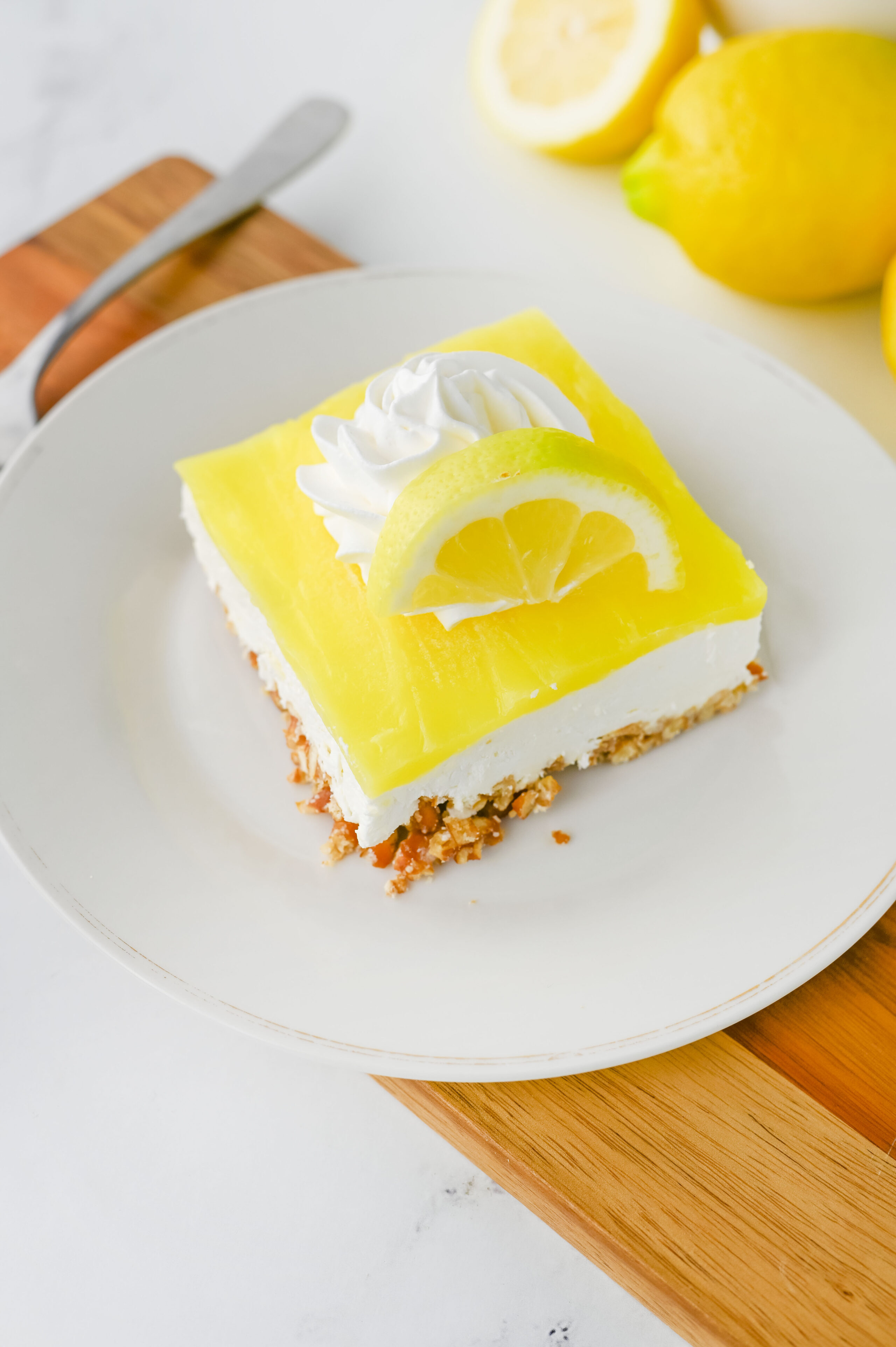 layered lemon dessert with cream cheese and lemon topping.