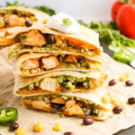 stacked chicken quesadillas on a cutting board ready to serve.