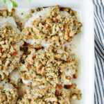 pork chops with stuffing in a white casserole dish.