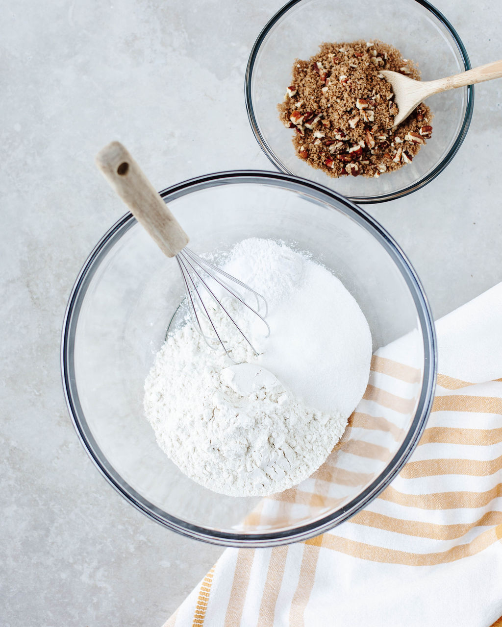 Dry ingredients being whisked together in a large mixing bowl.