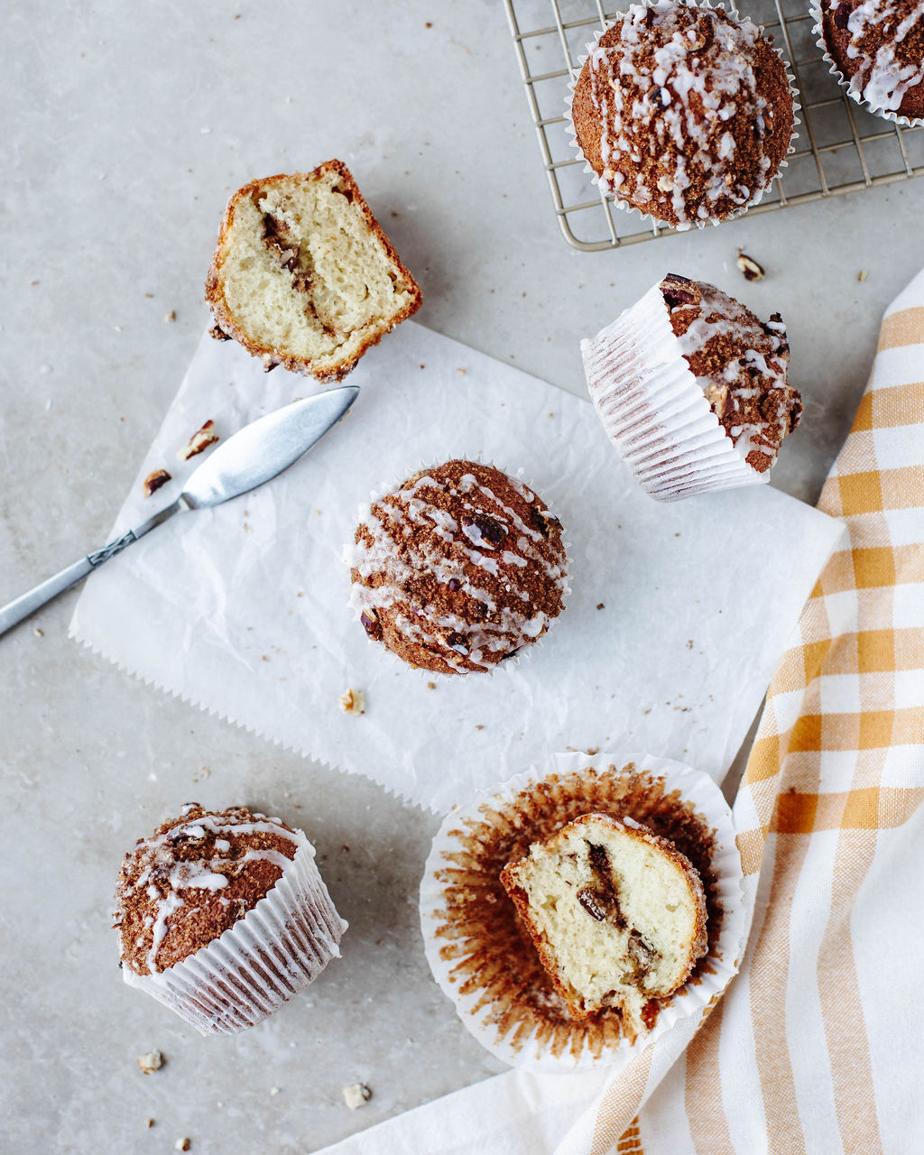 Unwrapped coffee cake muffin showing cinnamon swirl inside and fluffy texture.