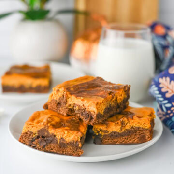 a stack of pumpkin pie spice brownie ready to serve from a white plate.