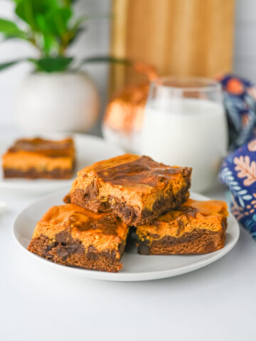 a stack of pumpkin pie spice brownie ready to serve from a white plate.
