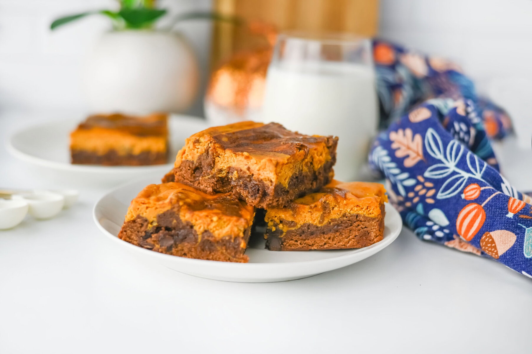 Close-up of moist pumpkin spice brownie showing chocolate layers and pumpkin swirl.