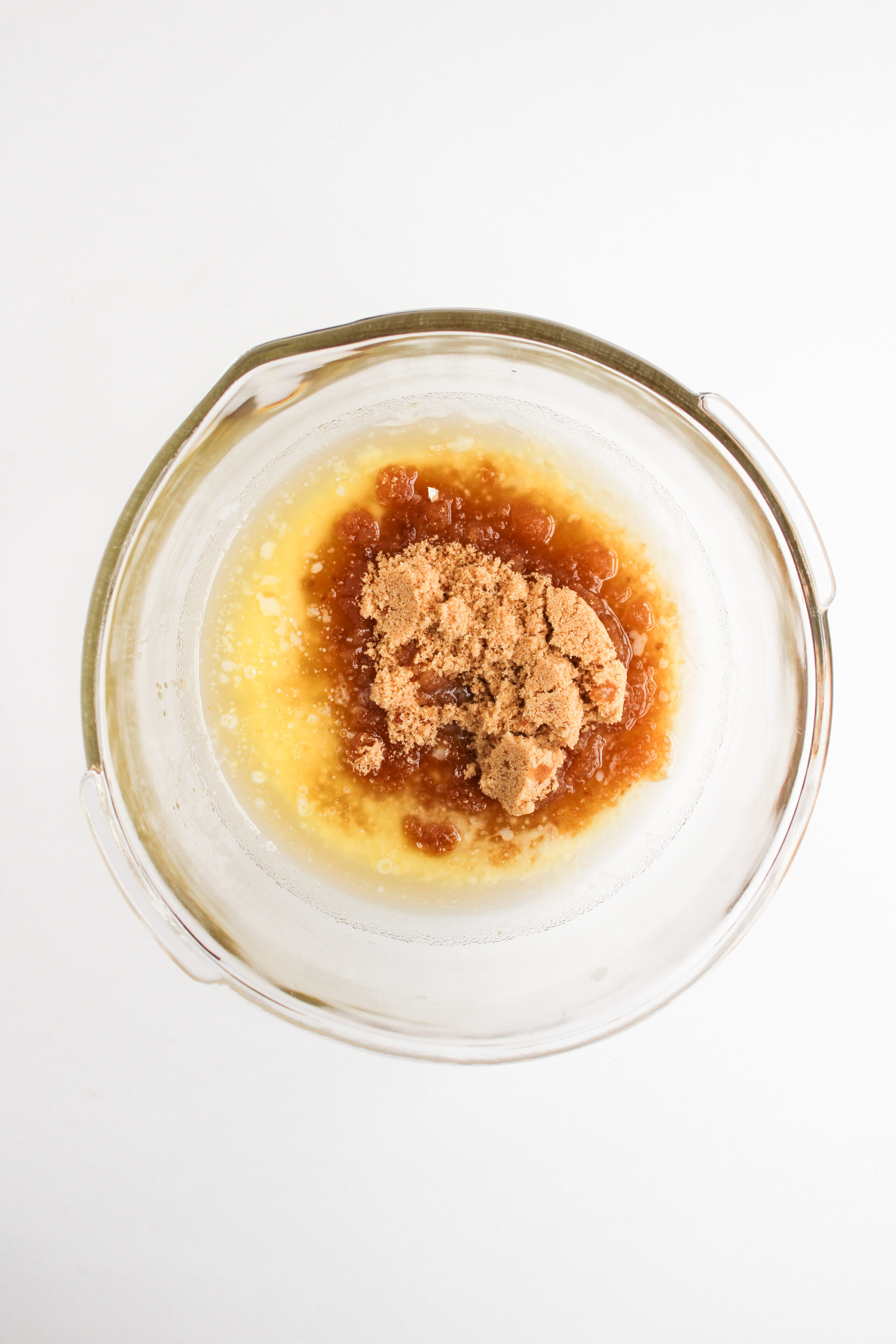 melted butter and brown sugar combined in a glass mixing bowl.