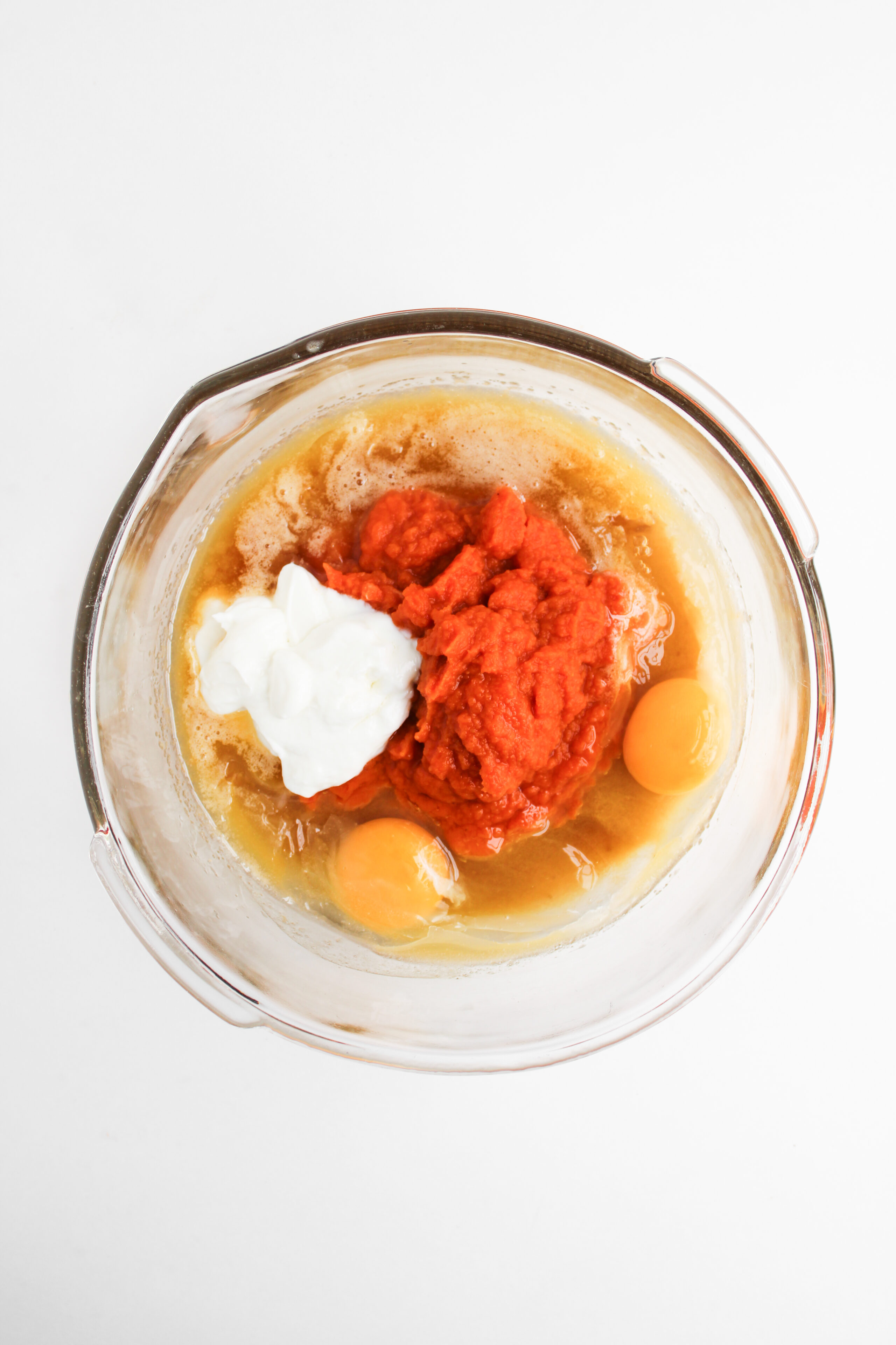 wet ingredients added to a mixing bowl.