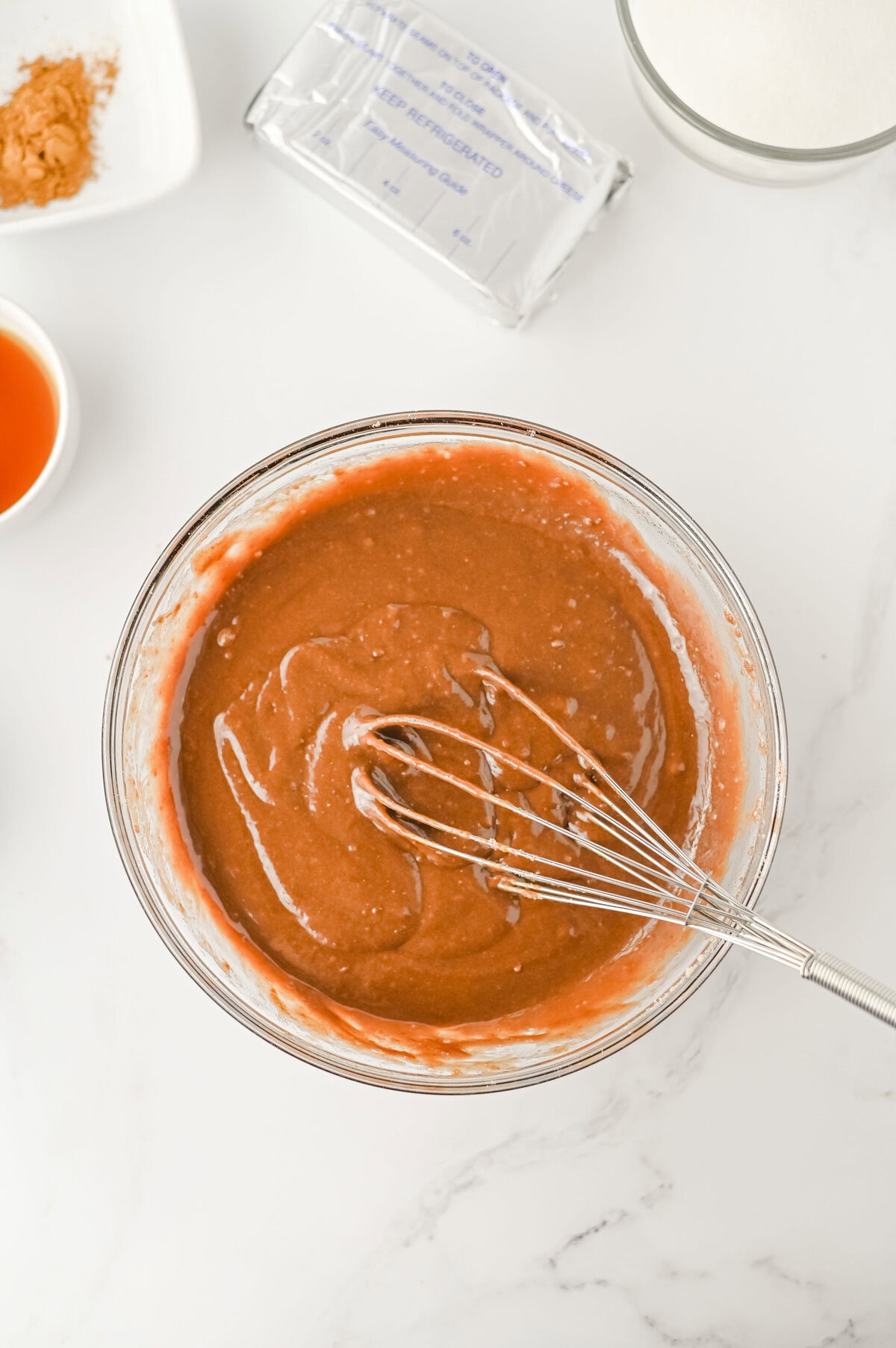 store bought brownie mix prepared in a glass mixing bowl.
