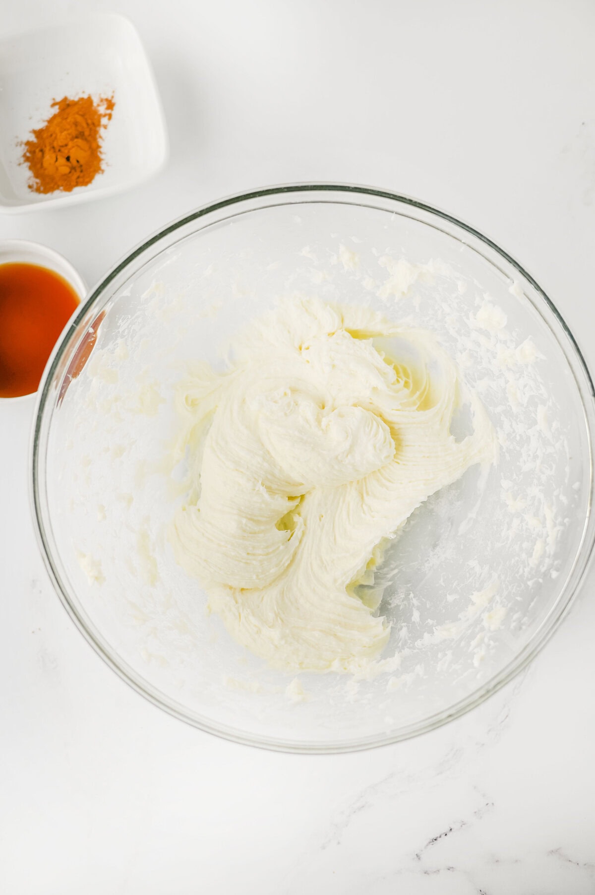 cream cheese and sugar creamed together in a mixing bowl.