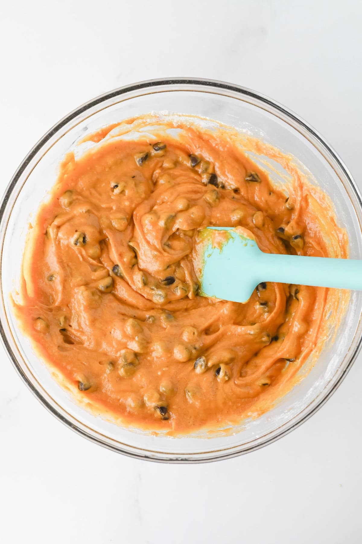 chocolate chips folded into pumpkin muffin batter.