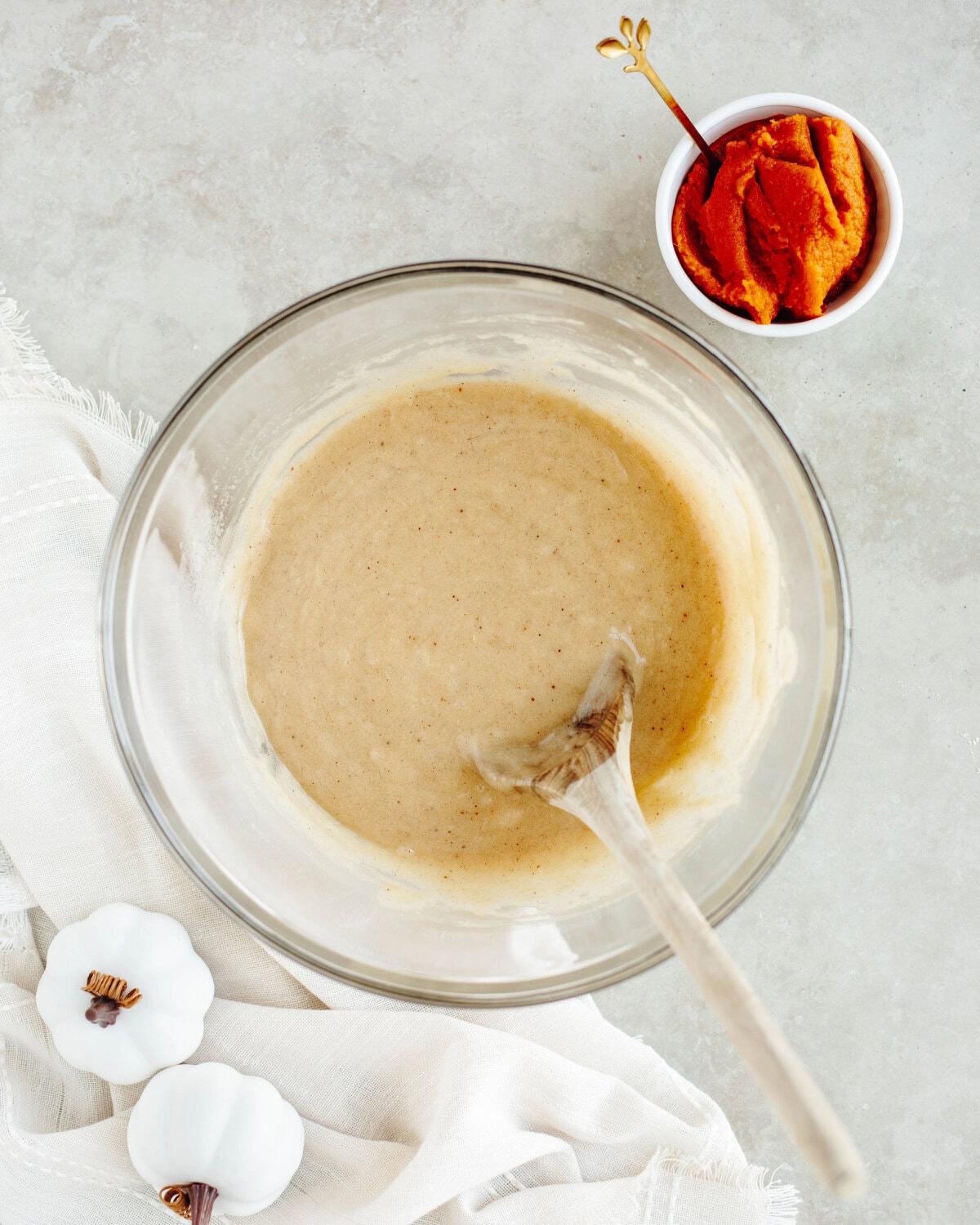 wet ingredients added into a glass mixing bowl to make quick bread.