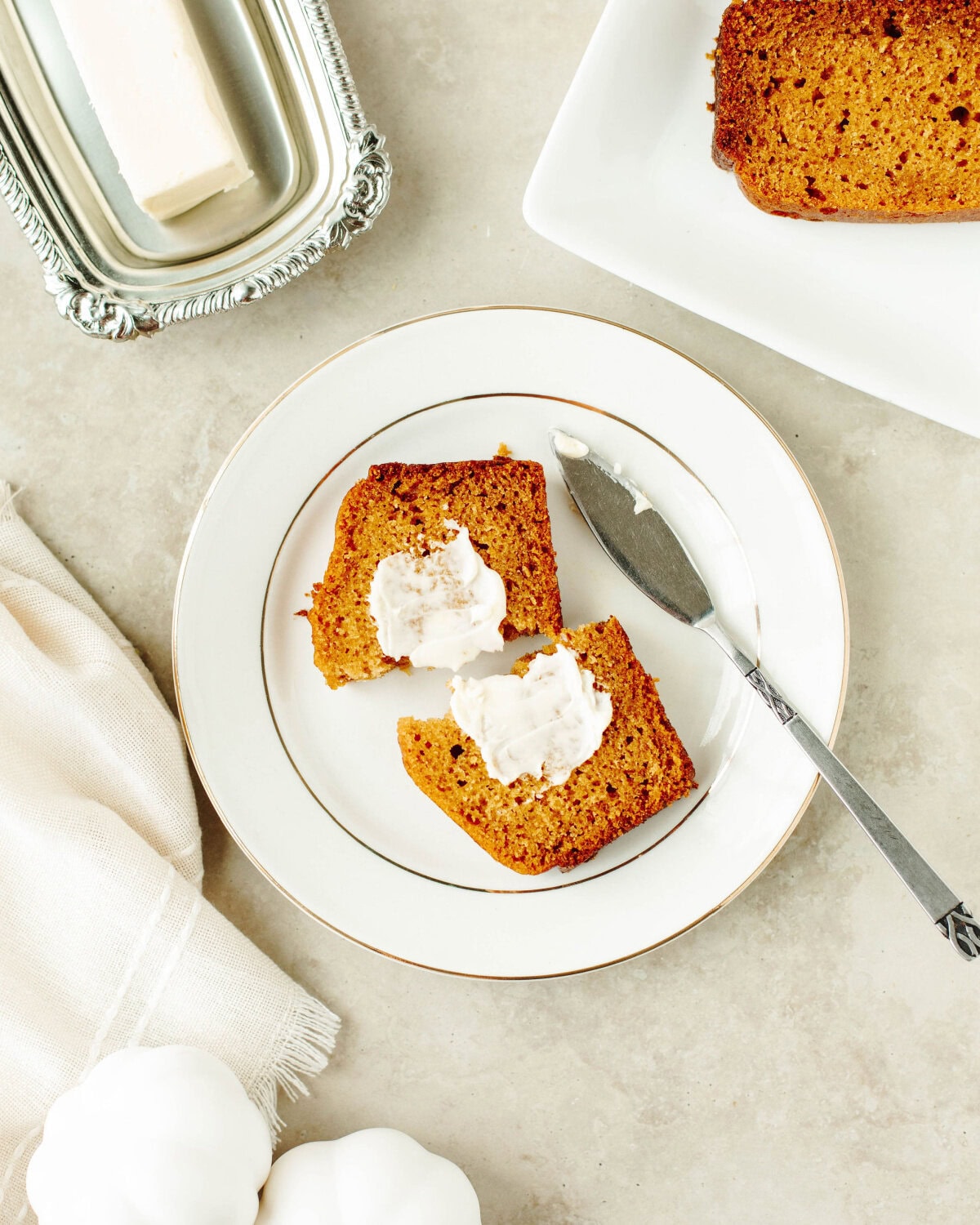 sliced Libby's pumpkin bread with butter on a white dish.