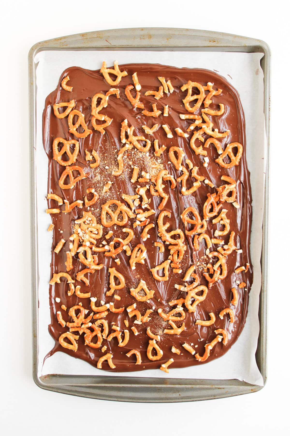 crushed pretzels spread on top of melted chocolate.