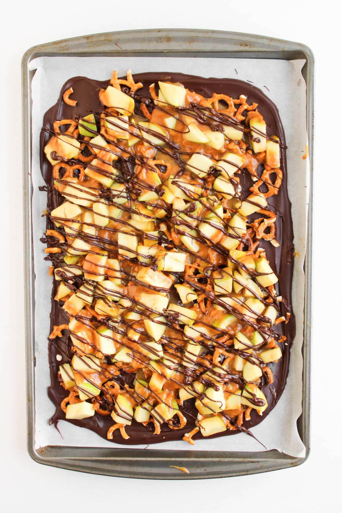 melted chocolate drizzled over the caramel apple bark.