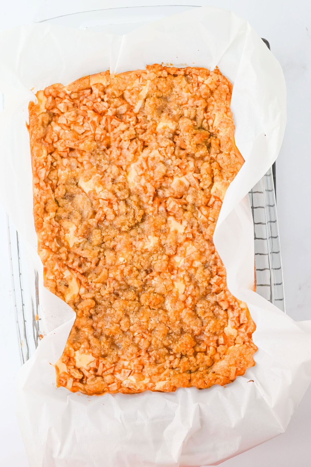 baked apple cheesecake bars in a 9x13 baking pan.
