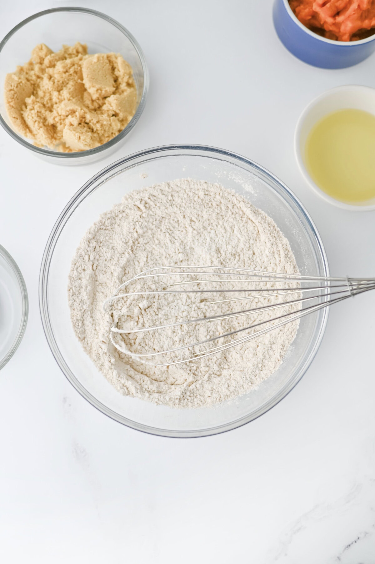 all the dry ingredients needed for pumpkin cream cheese bread combined in a glass mixing bowl.