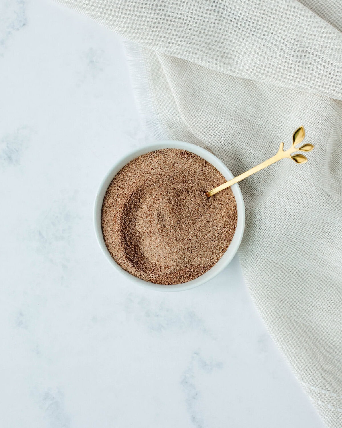 cinnamon and sugar combined in a small glass bowl.