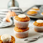 stacked pumpkin cream cheese muffins baked and ready to serve.