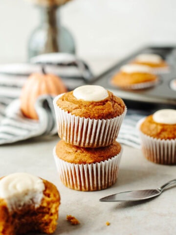stacked pumpkin cream cheese muffins baked and ready to serve.