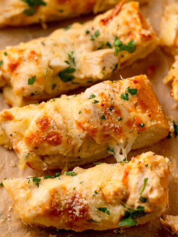 an up close look at a slice of Chicken Alfredo Garlic Bread.