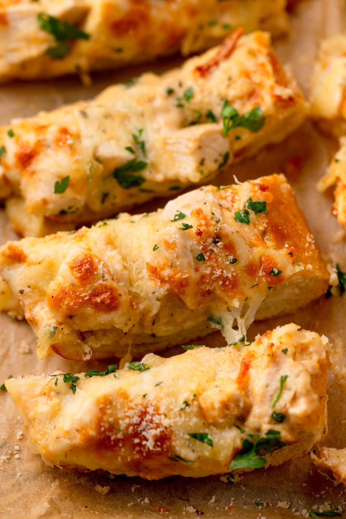an up close look at a slice of Chicken Alfredo Garlic Bread.