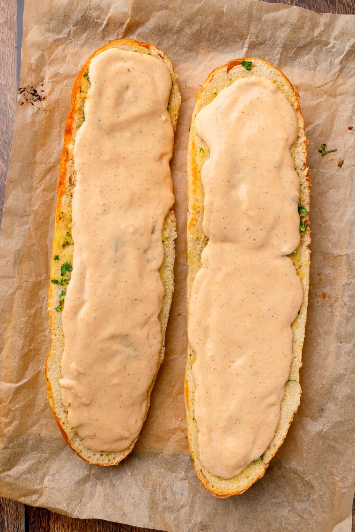 creamy Alfredo spread on top of garlic bread.