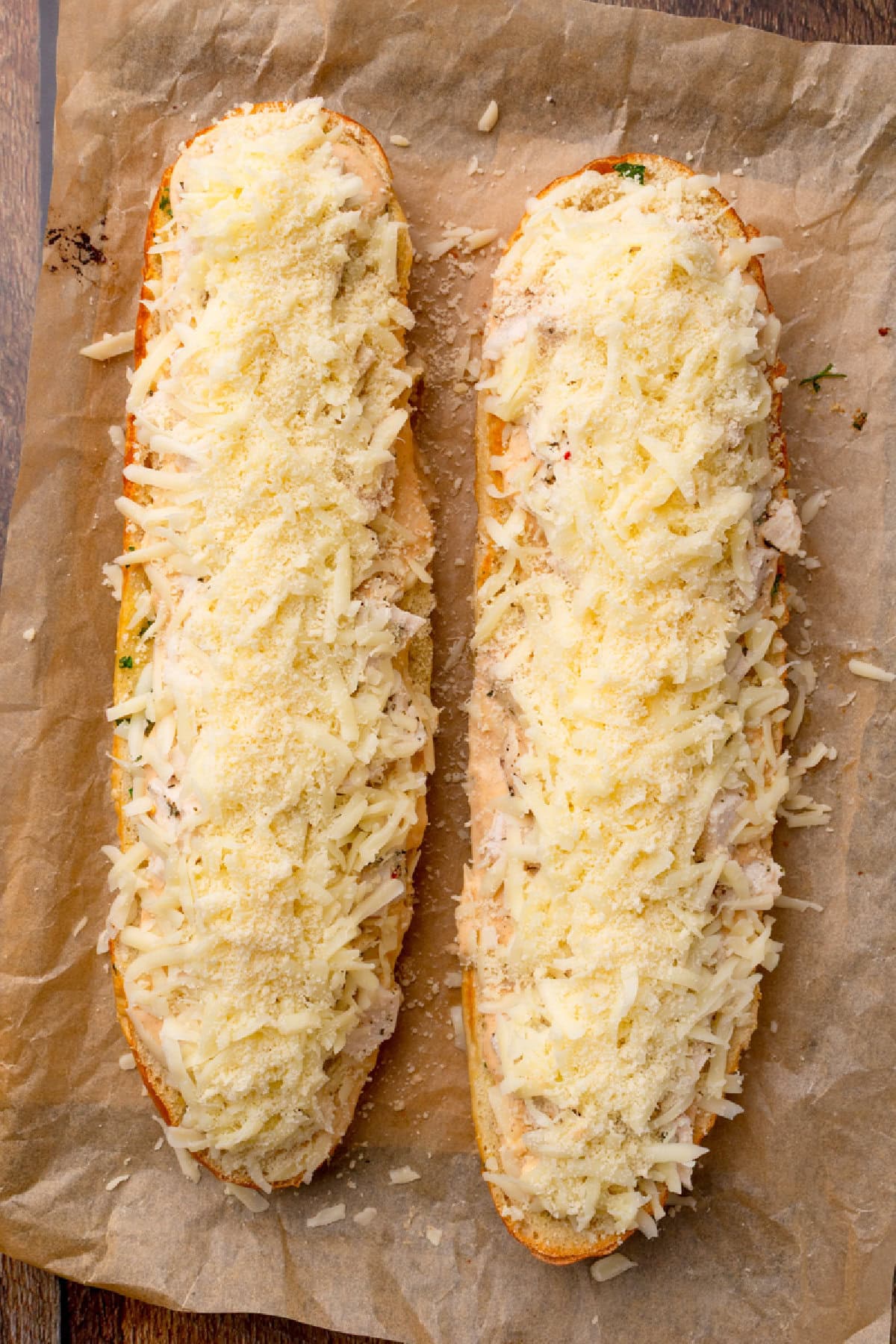 shredded Mozzarella and grated Parmesan cheese sprinkled on top of chicken and garlic bread.