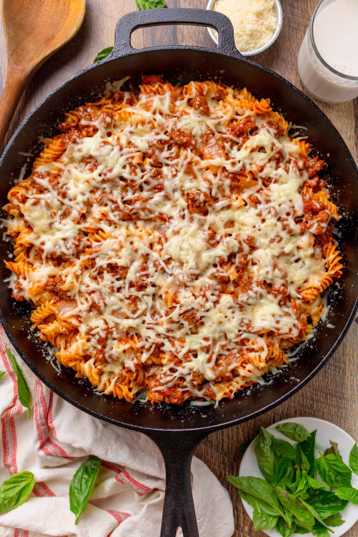cheesy baked pasta in a black cast iron skillet.
