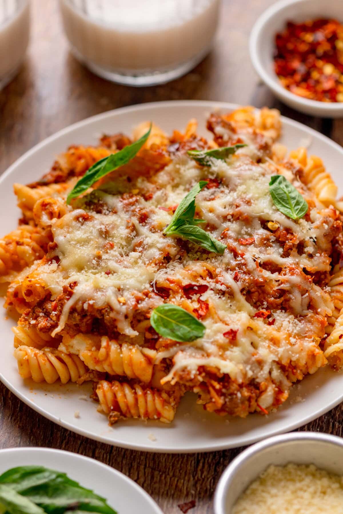 a serving of baked cheesy pasta on a white plate.