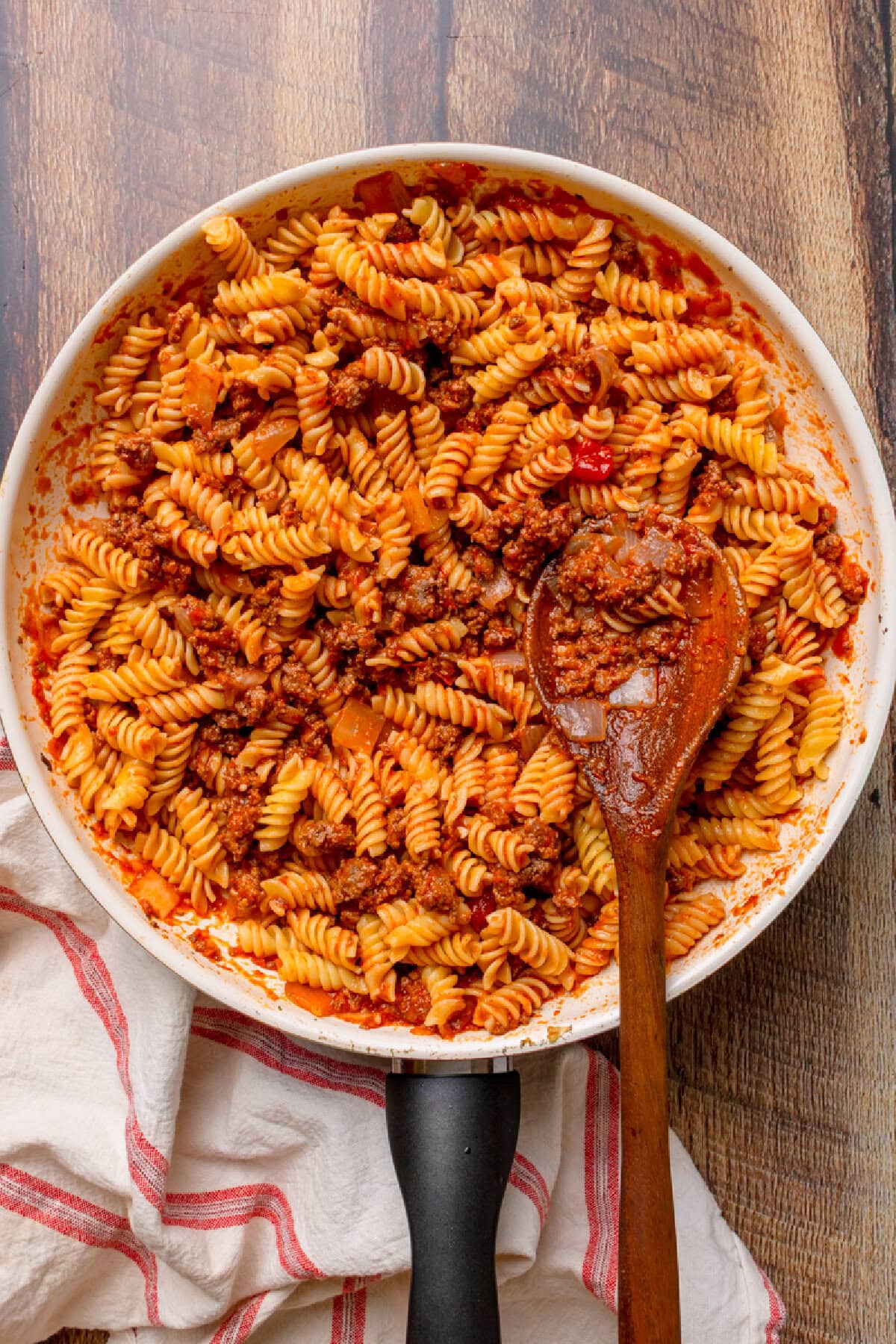 spaghetti sauce on top of cooked pasta and ground beef.