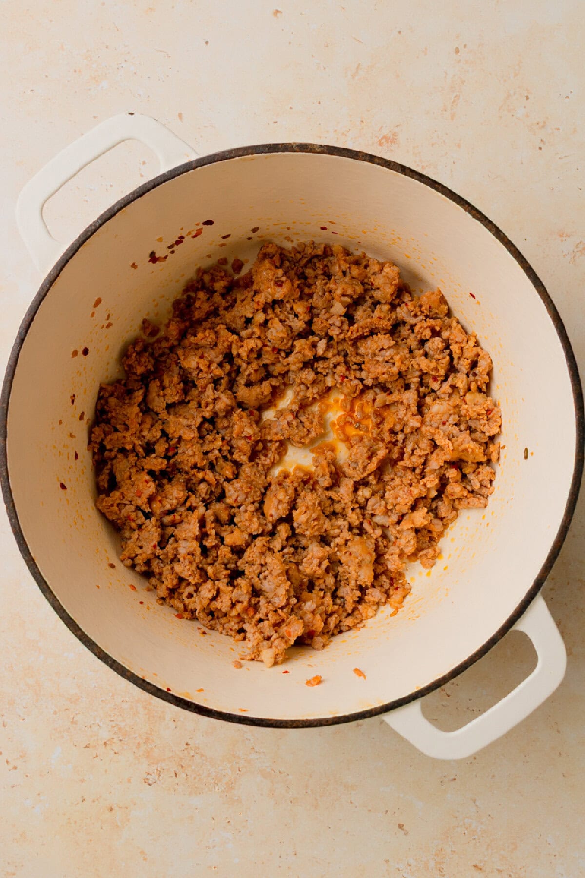 Italian sausage browned in a Dutch oven.