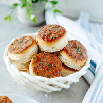 Freshly baked 7 Up Biscuits in a white basket, a simple way to serve Southern comfort food.