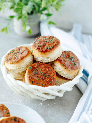 Freshly baked 7 Up Biscuits in a white basket, a simple way to serve Southern comfort food.